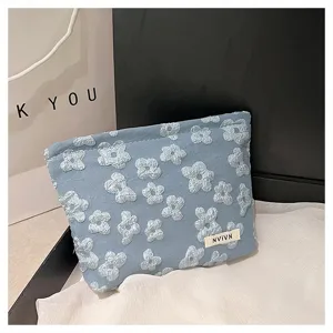 Portable blue floral cosmetic storage bag, large capacity travel toiletry pouch for daily use.