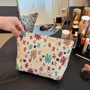 Linen jacquard cosmetic bag with floral pattern, portable travel makeup storage pouch for women.