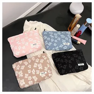 Detailed view of floral cosmetic bag showcasing fabric texture and spacious interior.