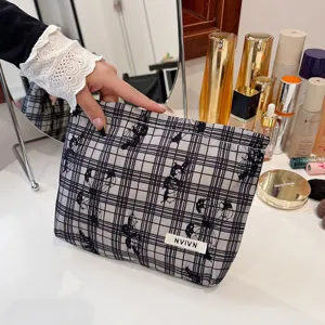 Detailed view of vintage plaid lace cosmetic bag, portable minimalist clutch storage bag.