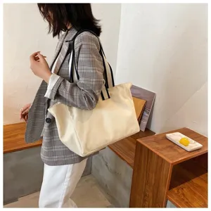 Canvas tote bag detail view showing spacious interior, durable fabric, and comfortable straps.