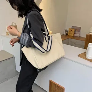 Minimalist large capacity canvas tote bag for women, stylish casual shoulder bag design.