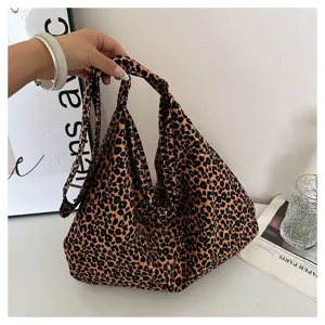 Close up of the slouchy leopard canvas tote bag, showing soft texture and large capacity.