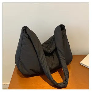 Detailed view of black quilted puffer shoulder bag, large capacity hobo tote for women casual.
