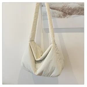 Minimalist white puffer shoulder bag, soft quilted hobo crossbody bag for casual style.