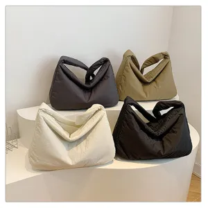 Padded shoulder bag detail view showing soft cloud pillow design with multiple colors available.