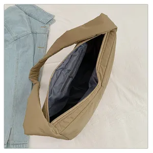 Detailed view of the khaki puffer hobo shoulder bag with zipper closure and inner pocket.