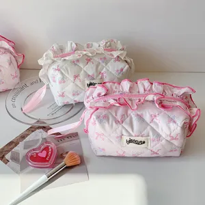Quilted floral cosmetic bag with cute bows and ruffles, portable travel toiletry pouch for daily use.