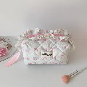 Quilted cosmetic pouch with ruffles, floral bow print, cute makeup bag for travel daily use.