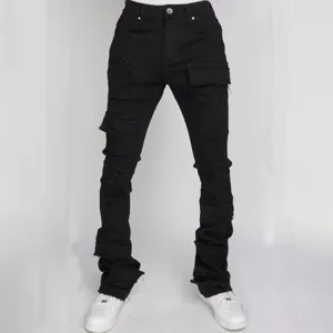 Black stacked cargo jeans for men with distressed details and flared hems for streetwear.