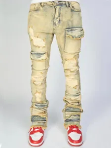 Men's distressed stacked cargo denim jeans detail shot showing multi-pockets and flare fit.