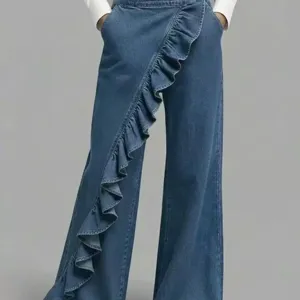 Trendy blue denim pants featuring chic asymmetric ruffles and a comfortable mid-waist fit.