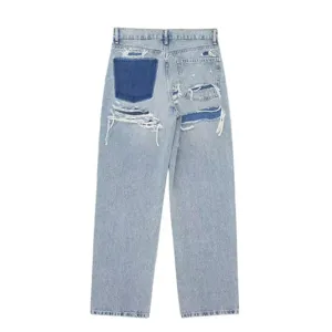 Detailed view of women's light blue distressed patchwork wide-leg denim jeans with back pockets.