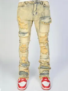 Detail shot of distressed cargo stacked denim jeans with multiple utility pockets and washed finish.