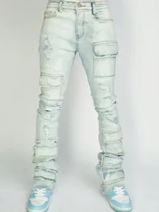 Detail view of light blue distressed stacked cargo jeans for men with multiple pockets.