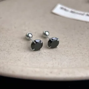 Detailed close-up of stainless steel black zirconia screw-back cartilage stud earrings.