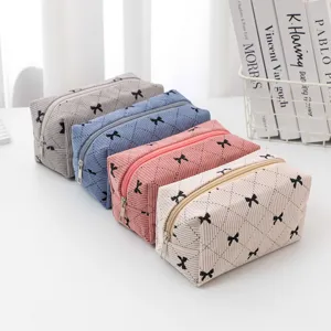 Corduroy cosmetic bag with cute bow pattern, large capacity portable makeup pouch for daily use.