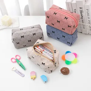 Corduroy cosmetic bag with cute bow design, large capacity portable storage pouch for travel.