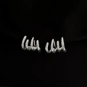 Silberne Ohrklemmen Detailaufnahme mit Krallen Textur fuer Nicht Ohrloecher Schmuck