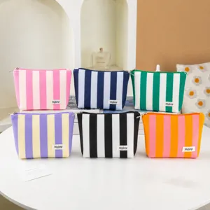 Striped canvas makeup bag, colorful cosmetic pouch with zipper, daily travel toiletry bag detail view.