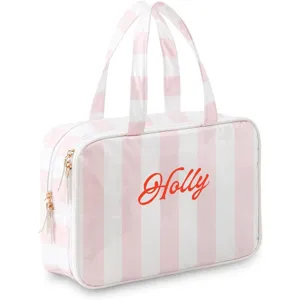 Detailed view of pink white stripe PVC cosmetic bag featuring dual top handles and smooth zipper.