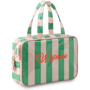 Waterproof PVC striped cosmetic bag with double handles and large capacity for travel storage.