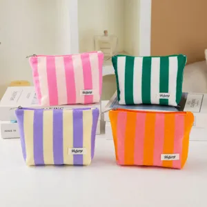 Colorful striped cosmetic bag with zipper closure, stylish makeup pouch for daily travel use.