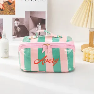 Detailed view of the pink and green striped PVC cosmetic bag showcasing custom Avery text.