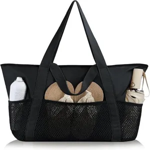 Detail view of the black mesh beach tote bag featuring front pockets and sturdy handles.