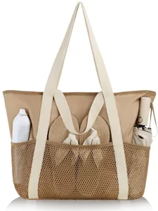 Beige mesh beach tote bag detail showing front pocket with accessories and sturdy handles.