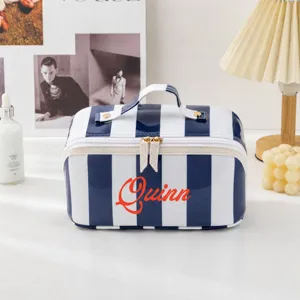 Blue and white striped PVC cosmetic bag with top handle, large capacity travel makeup pouch.