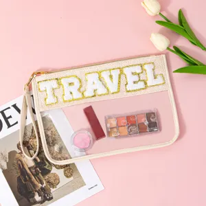 Clear PVC travel cosmetic bag detail shot showcasing chenille letter embroidery and stylish design.