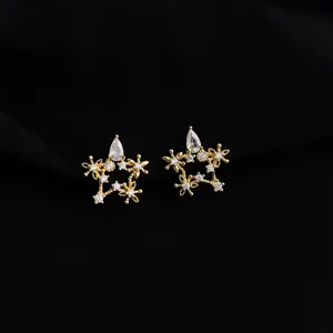 Close-up detail of exquisite gold star clip-on earrings sparkling with stunning cubic zirconia.