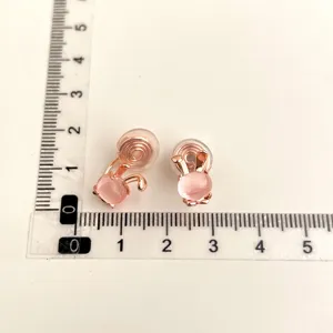 Detailed view of chic pink rabbit clip-on earrings with gold finish and measurement scale.