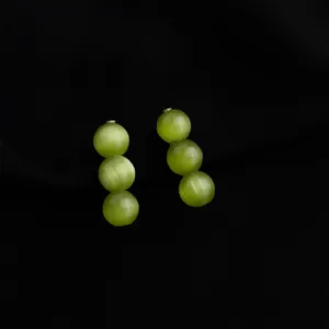 Detailed close-up of elegant green triple bead drop earrings with cat's eye finish for women.