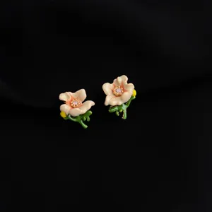 Elegant enamel flower clip-on earrings with green stems and sparkling crystal centers.