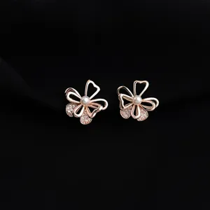 Elegant rose gold flower clip-on earrings with pearls and shimmering cubic zirconia stones.