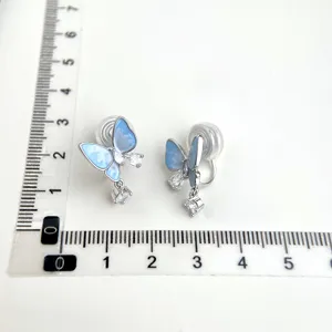 Elegante blaue Schmetterling Clip-Ohrringe mit funkelnden Kristallen für Ohrlöcher.