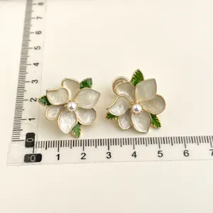 Elegant floral clip-on earrings with pearl center and green leaves for women.