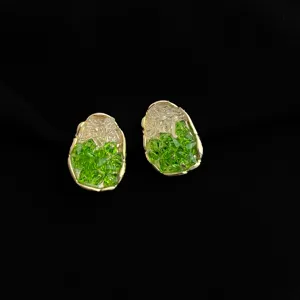 Exquisite green crystal irregular pebble clip earrings with 18k gold plated edge detail.