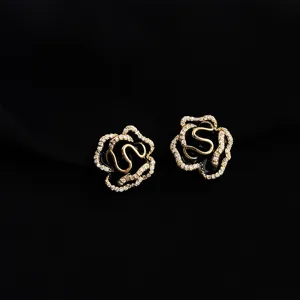 Exquisite camellia design clip-on earrings with sparkling rhinestones and elegant black enamel detail.