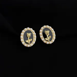 Vintage oval rose pearl clip earrings detail, elegant gold metal floral design jewelry.