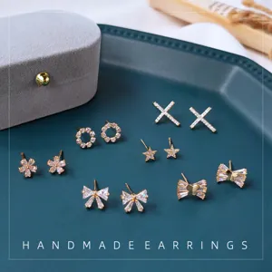 Schicke 14k vergoldete Zirkonia Ohrstecker Set mit süssen Schleifen und Stern Motiven.