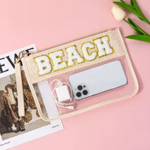 Clear PVC cosmetic bag with textured chenille BEACH letters detail close up display