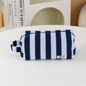 Blue and white striped cosmetic bag, plush portable toiletry pouch with zipper closure.