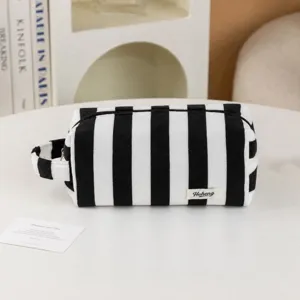 Striped plush cosmetic bag, portable toiletry bag with zipper and handle for travel.
