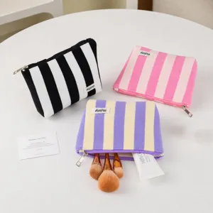 Striped cosmetic bag set, soft fabric makeup pouch with zipper closure, daily travel storage.