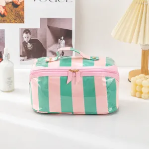 Detail view of colorful stripe PVC cosmetic bag, waterproof travel makeup pouch with handle.