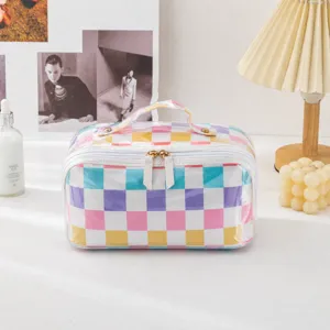 Detailed view of clear colorful checkered cosmetic pillow bag, large capacity travel organizer.