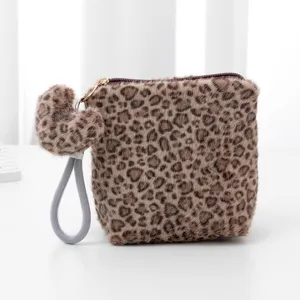 Fluffy leopard print cosmetic pouch with cute heart pendant and portable wrist strap.